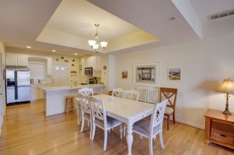 Ocean City MD Condo Rentals condo with full kitchen with white cabinets dining table and chairs
